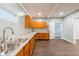This kitchen features wood cabinets, granite counters, stainless steel sink, and new dark floors at 350 N Belleview Pl, Indianapolis, IN 46222