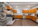 Well-equipped kitchen with wooden cabinets, stainless steel appliances, and stone accent wall at 350 N Belleview Pl, Indianapolis, IN 46222