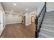 Open-concept living area with a fireplace and stairwell access to other floors at 350 N Belleview Pl, Indianapolis, IN 46222