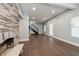 Bright living room featuring wood floors and a stunning stone fireplace at 350 N Belleview Pl, Indianapolis, IN 46222