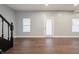 Spacious living room with wood floors and a door leading outside at 350 N Belleview Pl, Indianapolis, IN 46222
