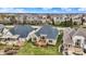 Aerial view of a brick house with a wood deck, surrounded by manicured lawns in a residential neighborhood at 4703 River Ridge Dr, Indianapolis, IN 46240