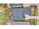 Birds-eye view of a home with a dark roof and wood deck, nestled in a green, landscaped yard at 4703 River Ridge Dr, Indianapolis, IN 46240