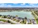 Panoramic aerial view of a lakeside community with luxury homes boasting manicured lawns and mature trees at 4703 River Ridge Dr, Indianapolis, IN 46240