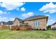A brick home featuring a charming wood deck and lush green lawn on a sunny day at 4703 River Ridge Dr, Indianapolis, IN 46240