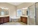 A luxurious primary bathroom features a tub, walk-in shower, and dual vanities at 4703 River Ridge Dr, Indianapolis, IN 46240