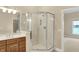 Corner glass shower is beside a brown vanity in this bathroom at 4703 River Ridge Dr, Indianapolis, IN 46240