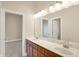 Bright bathroom featuring a double sink with a large mirror and wooden cabinetry at 4703 River Ridge Dr, Indianapolis, IN 46240