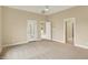Spacious bedroom with neutral carpet, ceiling fan, and natural light at 4703 River Ridge Dr, Indianapolis, IN 46240