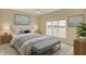 Comfortable main bedroom suite with a bench seat offers scenic waterfront views at 4703 River Ridge Dr, Indianapolis, IN 46240