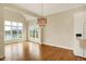 Open dining area with hardwood floors, scenic views, and a stylish chandelier at 4703 River Ridge Dr, Indianapolis, IN 46240