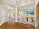 An open-concept dining room features hardwood floors, a modern light fixture, and seating for six at 4703 River Ridge Dr, Indianapolis, IN 46240
