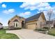 Lovely brick home with an attached two-car garage and well-maintained landscaping at 4703 River Ridge Dr, Indianapolis, IN 46240