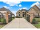 Elegant brick home featuring a gated entrance and a long driveway leading to the front door at 4703 River Ridge Dr, Indianapolis, IN 46240