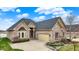 Beautiful brick home with an attached two-car garage and manicured landscaping at 4703 River Ridge Dr, Indianapolis, IN 46240