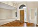 Spacious foyer featuring hardwood floors, arched doorway, and a stylish light fixture at 4703 River Ridge Dr, Indianapolis, IN 46240