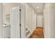 Hallway with wood floors, stairs, and utility sink at 4703 River Ridge Dr, Indianapolis, IN 46240