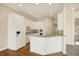 Well-lit kitchen featuring white cabinets, a breakfast bar, and modern appliances at 4703 River Ridge Dr, Indianapolis, IN 46240