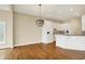 Bright kitchen featuring white cabinetry, a breakfast bar and hardwood floors at 4703 River Ridge Dr, Indianapolis, IN 46240