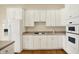 Bright kitchen featuring white cabinetry, countertops, and built-in oven microwave, perfect for modern living at 4703 River Ridge Dr, Indianapolis, IN 46240