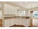 Bright kitchen featuring white cabinetry, a sink, and an open layout, perfect for modern living and entertaining at 4703 River Ridge Dr, Indianapolis, IN 46240
