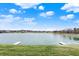 Beautiful lake view featuring a lush green lawn and docks at 4703 River Ridge Dr, Indianapolis, IN 46240