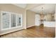 Open-concept living space showcasing hardwood floors, neutral walls, and access to the kitchen at 4703 River Ridge Dr, Indianapolis, IN 46240