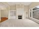 Bright living room featuring a fireplace with white mantle and large windows with natural light at 4703 River Ridge Dr, Indianapolis, IN 46240