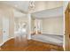 Open-concept living room with hardwood floors, pillars, and plenty of natural light at 4703 River Ridge Dr, Indianapolis, IN 46240