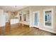 Open-concept living space showcasing hardwood floors, neutral walls, and access to the kitchen at 4703 River Ridge Dr, Indianapolis, IN 46240