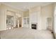 Open-concept living room featuring a fireplace, high ceilings and lots of natural light at 4703 River Ridge Dr, Indianapolis, IN 46240
