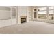 Spacious living room featuring a fireplace, built-in shelving, and large windows with scenic views at 4703 River Ridge Dr, Indianapolis, IN 46240