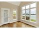 Light-filled sun room with large windows offering scenic waterfront views and access to the outdoors at 4703 River Ridge Dr, Indianapolis, IN 46240