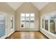 Light-filled sun room with large windows offering scenic waterfront views and access to the outdoors at 4703 River Ridge Dr, Indianapolis, IN 46240
