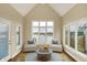 This bright sunroom offers serene lake views through large windows, creating a tranquil retreat at 4703 River Ridge Dr, Indianapolis, IN 46240