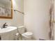 Simple bathroom with a pedestal sink, toilet, and patterned shower curtain at 4812 Eastgate Dr, Columbus, IN 47203
