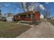 Traditional brick ranch with mature trees and a front porch; driveway to the right at 4812 Eastgate Dr, Columbus, IN 47203