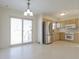Bright kitchen with stainless steel appliances, light cabinets, and a sliding glass door at 4812 Eastgate Dr, Columbus, IN 47203
