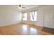 Bright living room featuring hardwood floors, a ceiling fan, and two windows for natural light at 4812 Eastgate Dr, Columbus, IN 47203