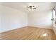 Spacious, bright room with hardwood floors, ceiling fan and natural light from a side window at 4812 Eastgate Dr, Columbus, IN 47203