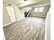 Bright, finished basement with wood-look floors, stairs, and natural light from the windows at 5608 Lunsford Dr, Indianapolis, IN 46237