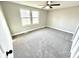 Spacious bedroom with neutral carpet, paint, ceiling fan, and windows offering natural light at 5608 Lunsford Dr, Indianapolis, IN 46237