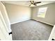 Cozy bedroom with neutral carpet, paint, and a window offering natural light at 5608 Lunsford Dr, Indianapolis, IN 46237