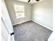 Bedroom featuring neutral carpet and paint, with a window offering natural light at 5608 Lunsford Dr, Indianapolis, IN 46237