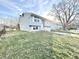 Two-story home with light blue siding, shuttered windows, a front porch, and a well-maintained lawn at 5608 Lunsford Dr, Indianapolis, IN 46237