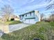 Light blue home with a two-car garage, white shutters, and a well-kept lawn on a sunny day at 5608 Lunsford Dr, Indianapolis, IN 46237