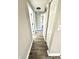 Hallway featuring neutral paint and flooring, with doors leading to other rooms at 5608 Lunsford Dr, Indianapolis, IN 46237
