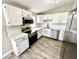 This kitchen features stainless steel appliances, white subway tile backsplash, and white cabinets at 5608 Lunsford Dr, Indianapolis, IN 46237