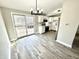 Bright eat-in kitchen featuring white cabinets, stainless steel appliances, and sliding glass door to deck at 5608 Lunsford Dr, Indianapolis, IN 46237