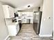 Updated kitchen boasts stainless steel appliances, white cabinets, and modern countertops at 5608 Lunsford Dr, Indianapolis, IN 46237
